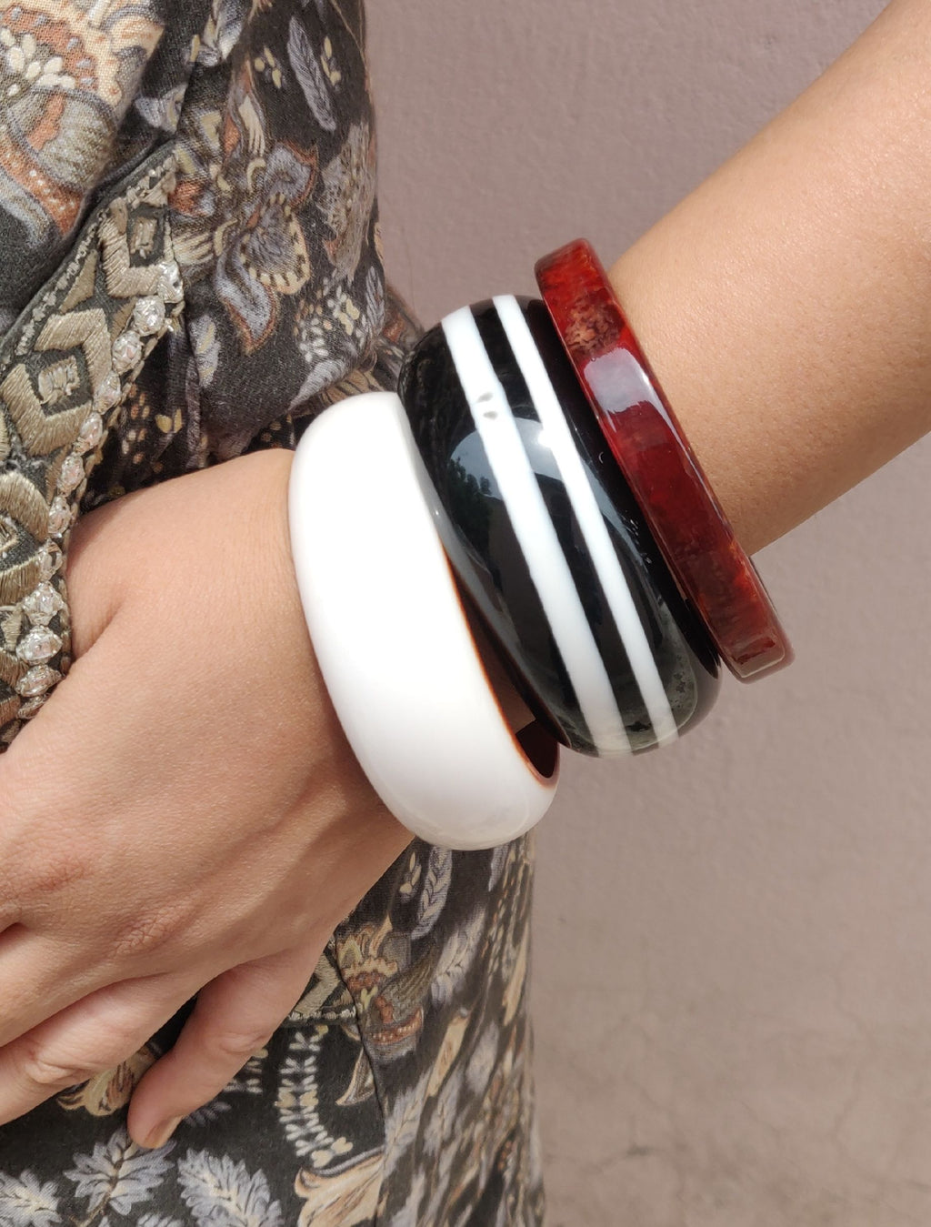 AIVY LUXE red and white resin bracelet set worn on wrist with black and white striped bracelet