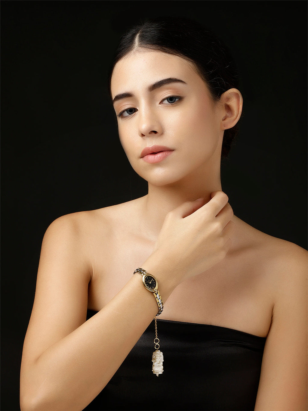 AIVY LUXE Shaandar Zar luxury charm hanging from a stylish gold and black watch on a woman’s wrist