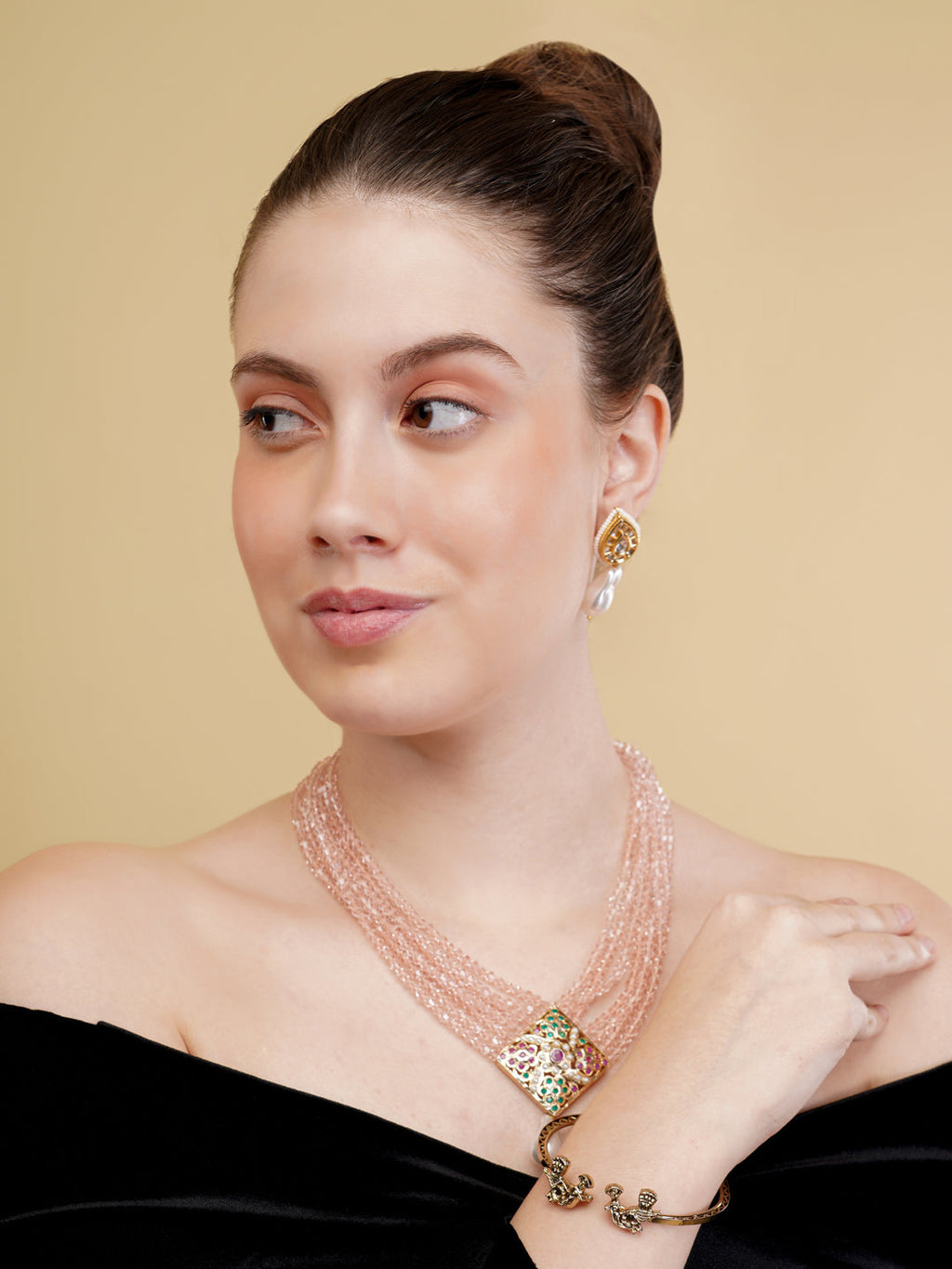 AIVY LUXE statement pearl necklace with multiple strands worn by a woman in a black off-shoulder top