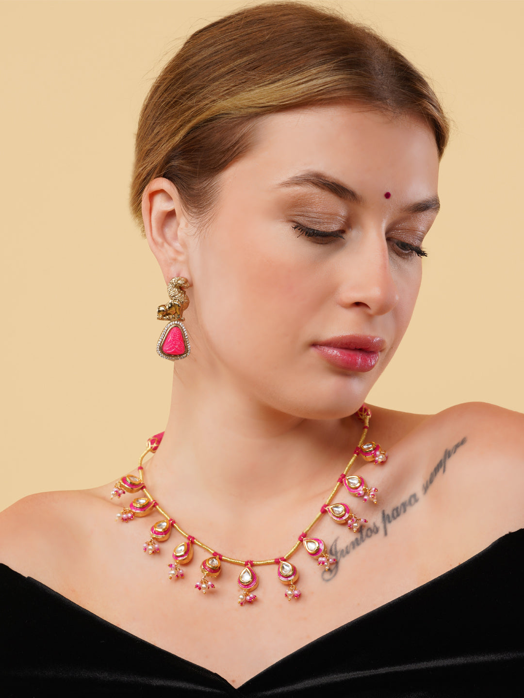 AIVY LUXE statement pink gemstone necklace with gold setting worn by woman with matching earrings