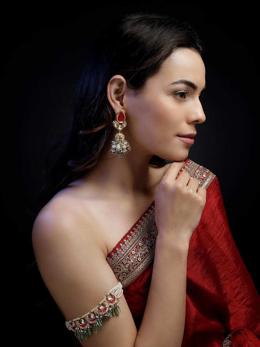 AIVY LUXE traditional gemstone bajuband worn on arm with red saree and matching earrings