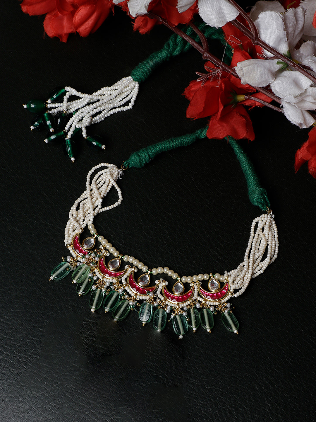AIVY LUXE traditional gemstone bajuband with white pearls and green gemstone accents on black background