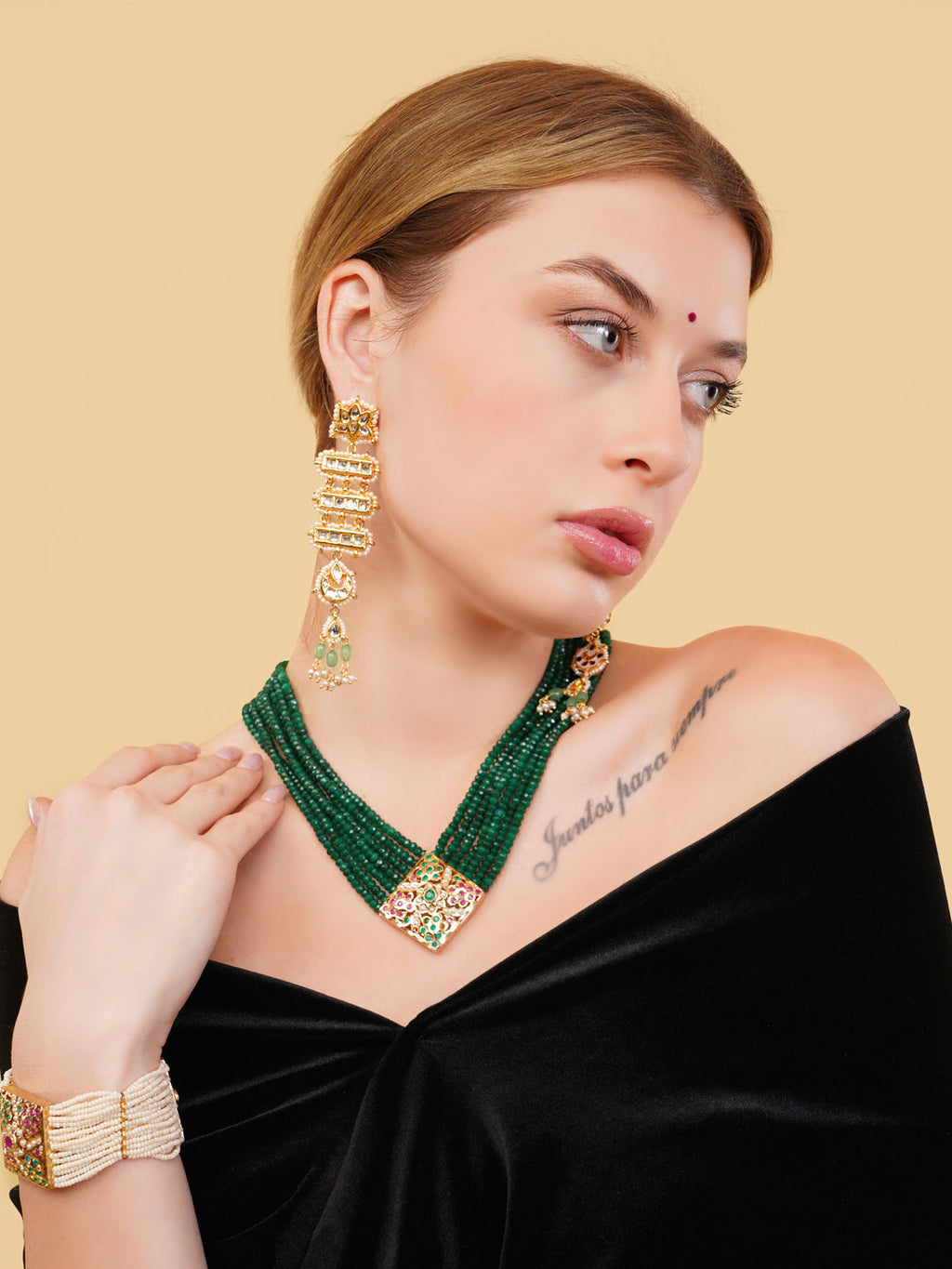 AIVY LUXE green beaded necklace with gold accents worn by model in black off-shoulder top