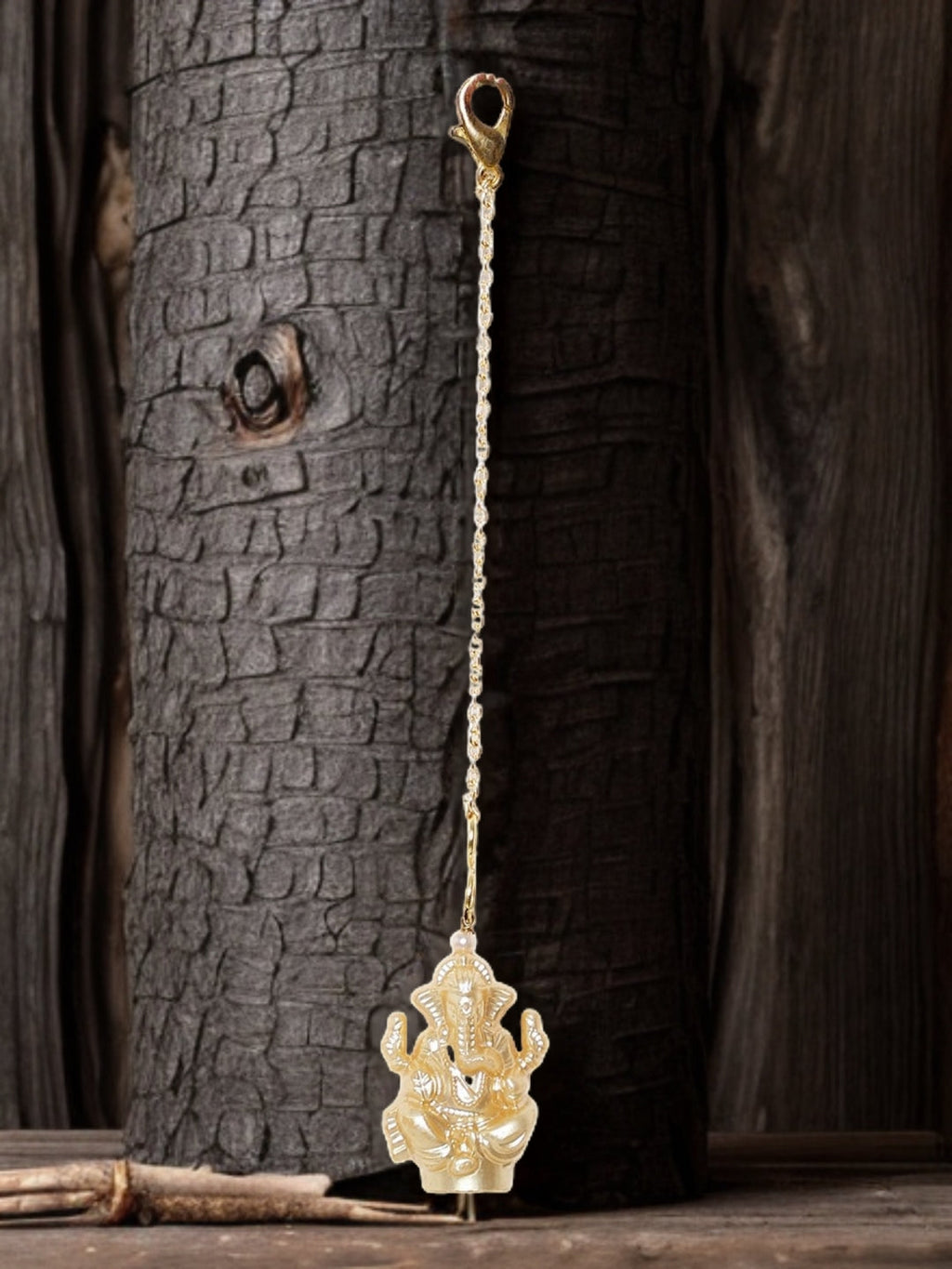 AIVY LUXE unique luxury watch charms for women featuring detailed gold elephant design hanging against rustic wood background