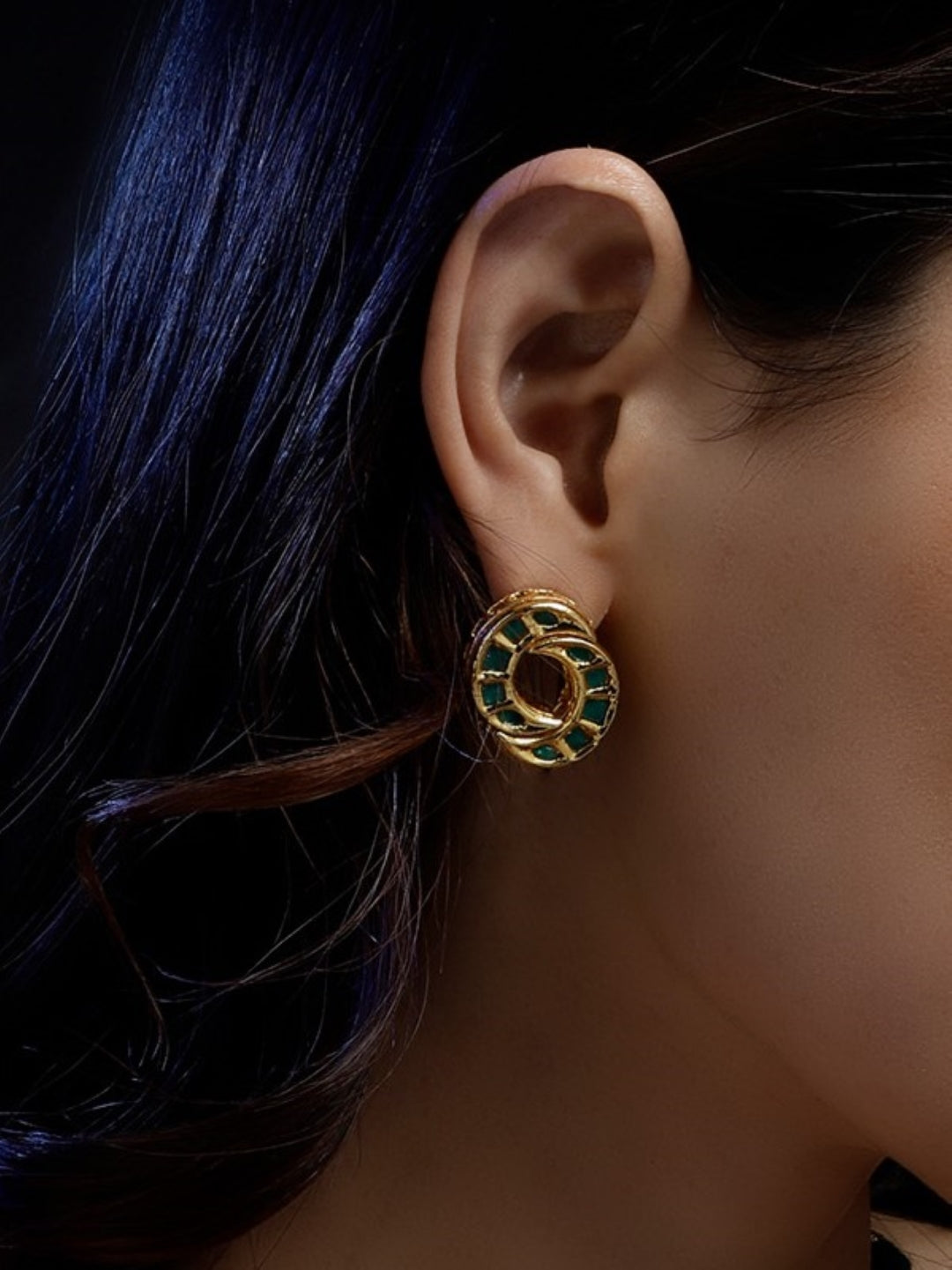 AIVY LUXE unique shamrock statement earrings in gold with green accents worn on ear