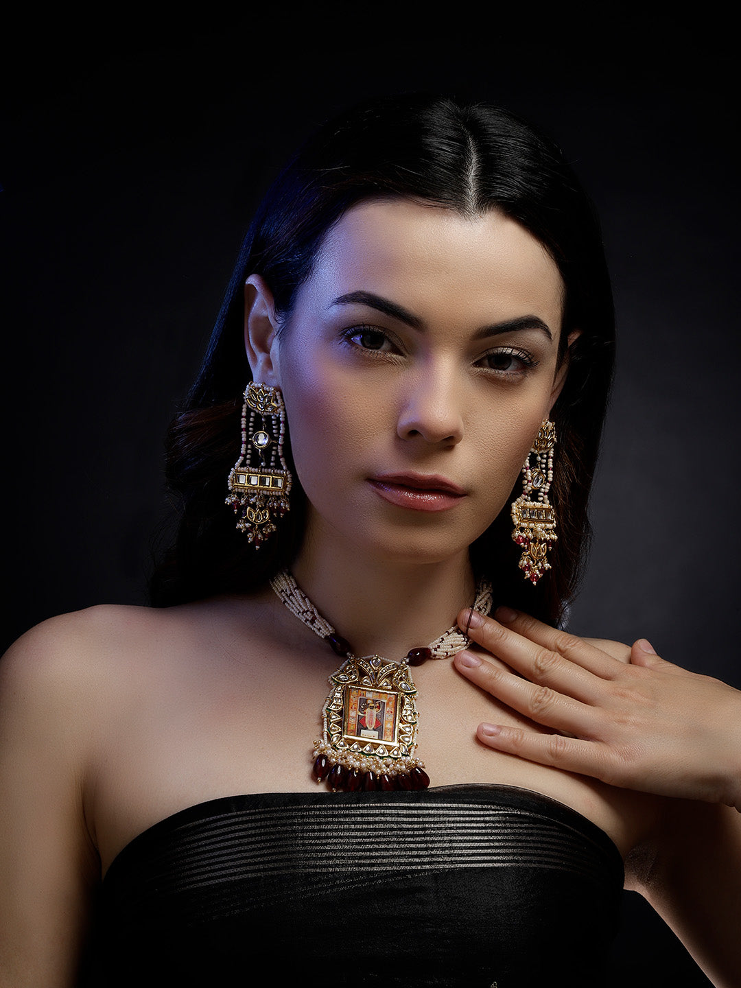 AIVY LUXE Anar-e-Zar Haar necklace worn by a woman with matching earrings on black background