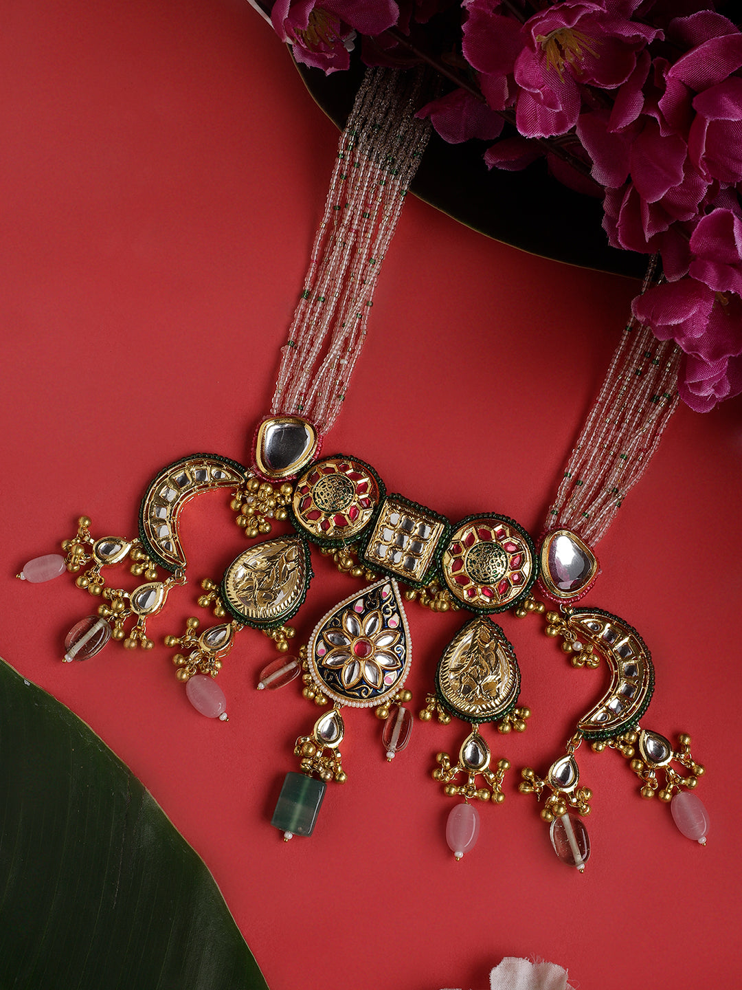 AIVY LUXE designer bridal choker set with intricate gold detailing and colorful gemstones on red background