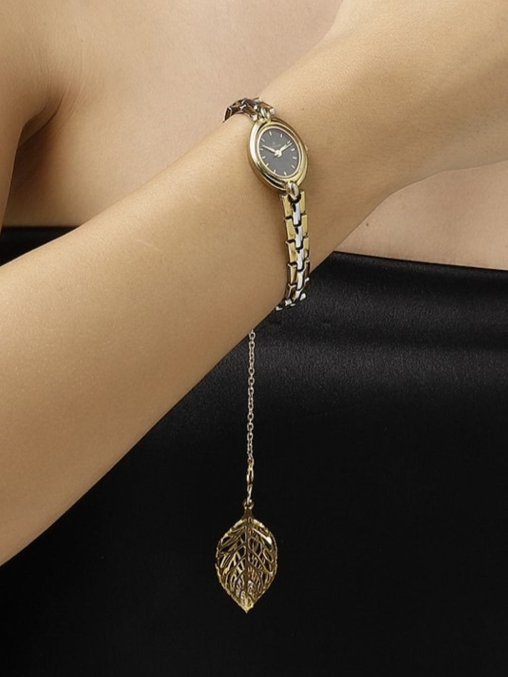 Handcrafted watch charm for women featuring gold leaf pendant attached to elegant wristwatch band