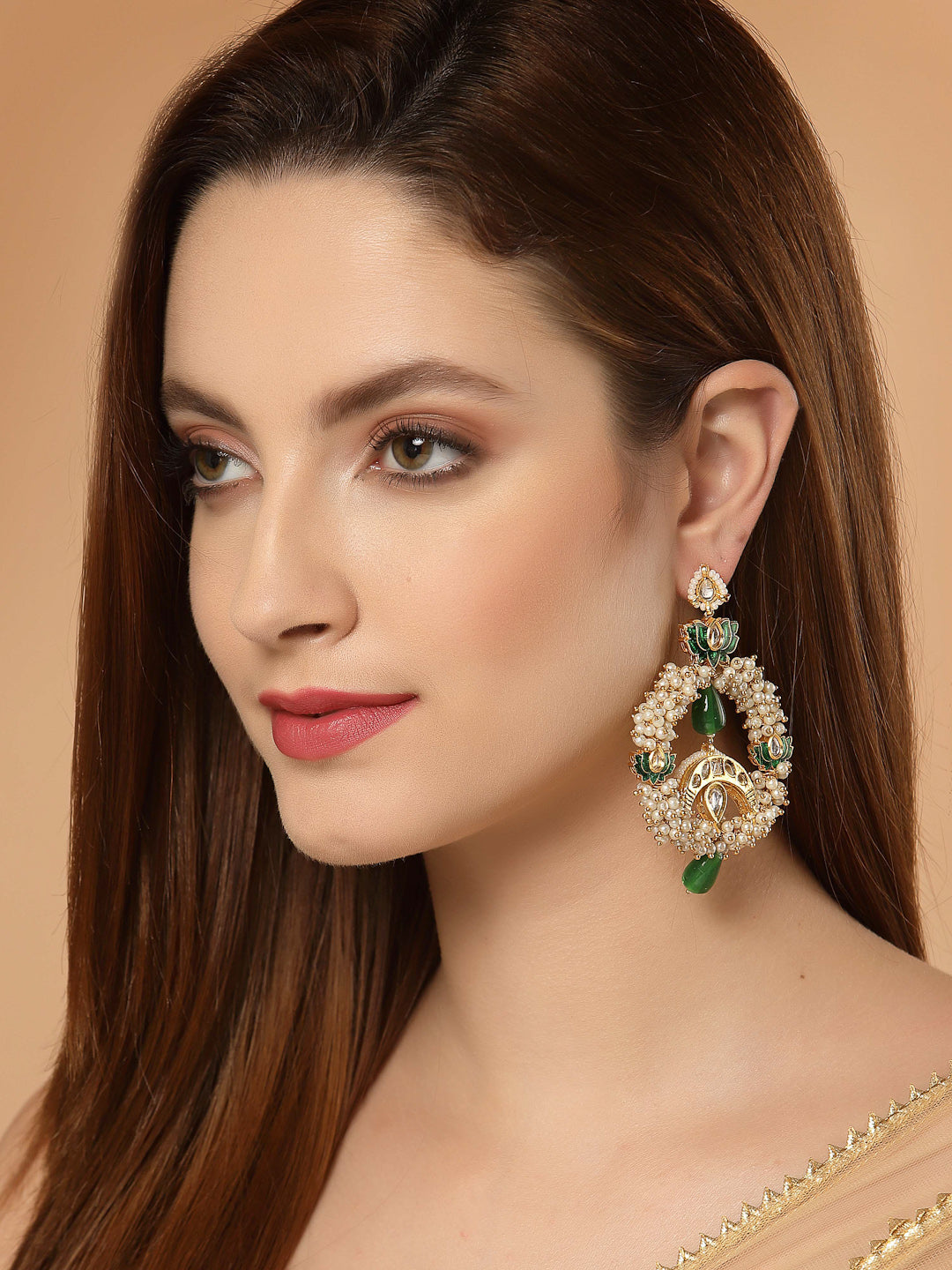 AIVY LUXE luxury ethnic earrings online worn by woman featuring intricate green and gold design with pearl accents