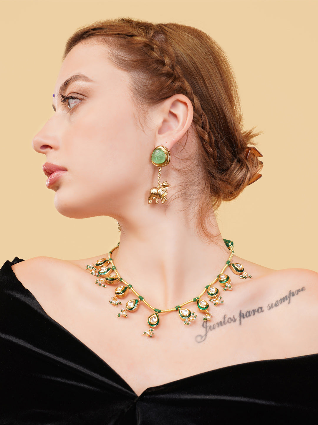 Luxury Indian necklace for women with green and gold detailing worn with matching earrings
