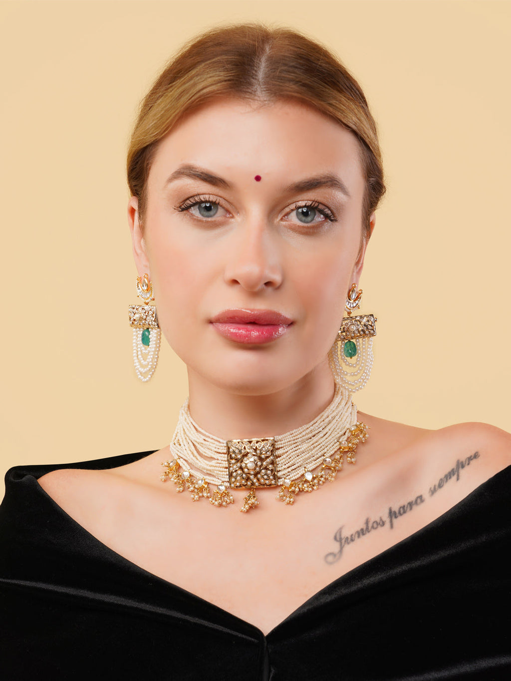 AIVY LUXE Zamrud drop earrings featuring green stones and pearl accents worn by a woman with a beige background